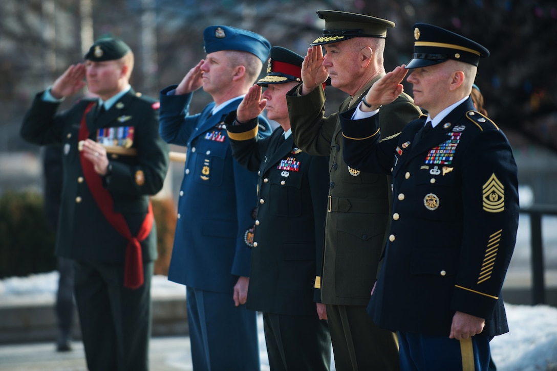 U.S. and Canadian defense leaders salute during a wreath-laying ceremony in Ottawa, Canada.