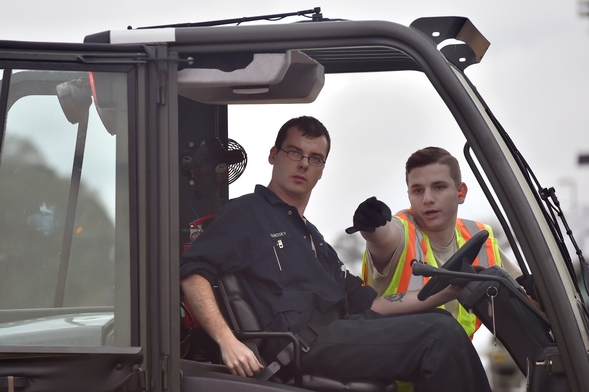Senior Airman Nicholas Thompson, 437th Aerial Port Squadron, right, directs a forklift operator through a cargo deployment function during a simulated cargo inspection as part of mobility exercise Bold Eagle Feb. 26, at Joint Base Charleston, S.C.