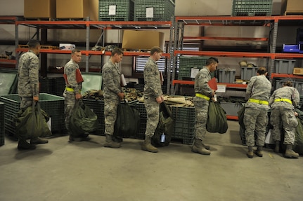 Airmen participating in mobility exercise Bold Eagle are issued individual personal protection equipment Feb. 27, 2018, at Joint Base Charleston, S.C.