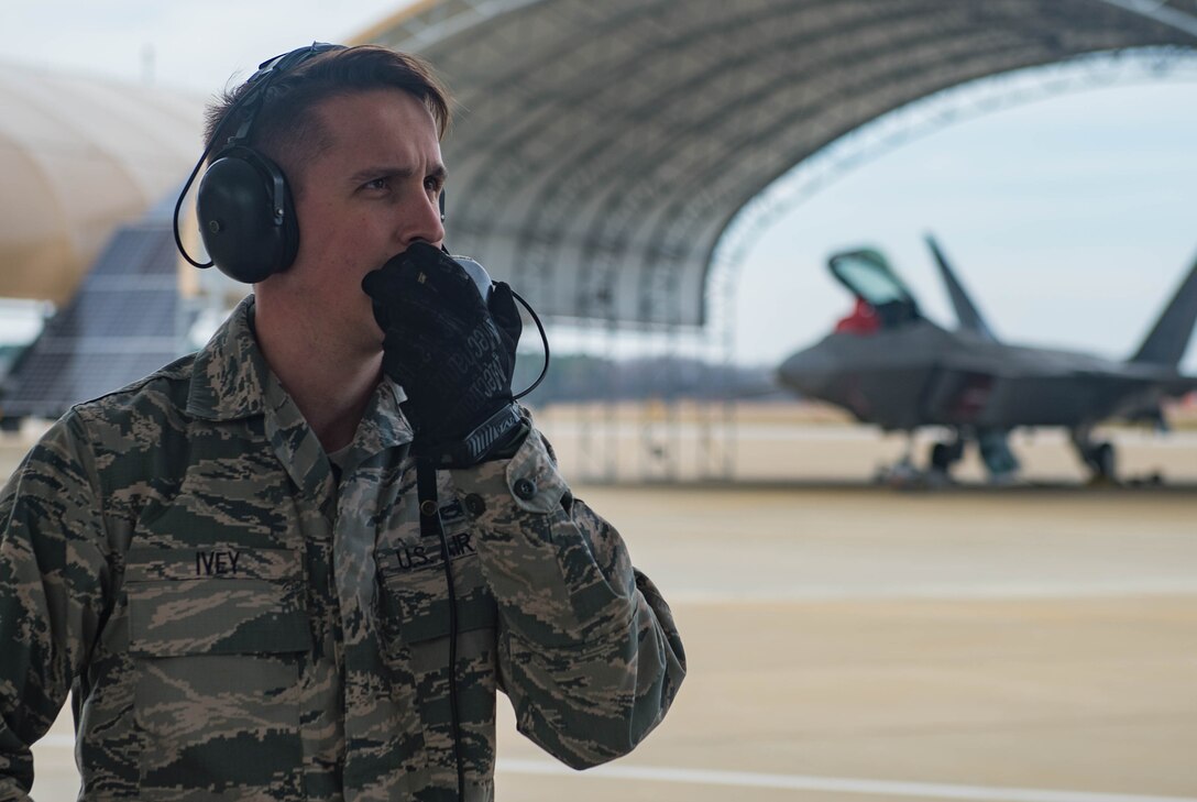 U.S. Air Force Staff Sgt. Ian Ivey, 27th Aircraft Maintenance Unit dedicated crew chief, checks communication equipment for an F-22A Raptor pilot at Joint Base Langley-Eustis, Virginia, Feb. 14, 2018. The crew chief and pilot go through checklist prior to flight to ensure the aircraft is in proper working condition. (U.S. Air Force photo by Senior Airman Derek Seifert)
