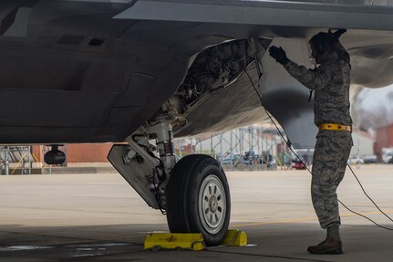U.S. Air Force Staff Sgt. Ian Ivey, 27th Aircraft Maintenance Unit dedicated crew chief, performs a pre-flight inspection of an F-22A Raptor at Joint Base Langley-Eustis, Virginia, Feb. 14, 2018. Dedicated crew chiefs are responsible for all work that needs to be accomplished on their assigned aircraft and ensuring the aircraft is ready for flight. (U.S. Air Force photo by Senior Airman Derek Seifert)