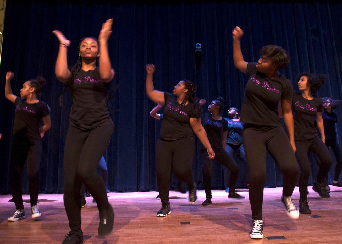 The Newport News Woodside High School Step dance team performed their routine of hand-claps and footsteps during a Black History Month ceremony at Joint Base Langley-Eustis, Virginia, Feb. 23, 2018. Step dance performers use their bodies as instruments to produce rhythms and sounds through hand-claps and footsteps. (U.S. Air Force photo by Airman 1st Class Monica Roybal)