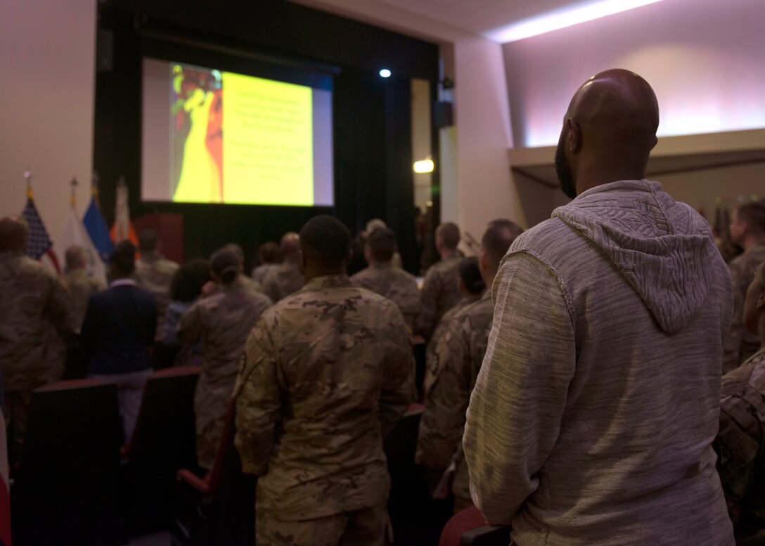 Audience members watch a presentation at a Black History Month ceremony in at Joint Base Langley-Eustis, Virginia, Feb. 23, 2018. The ceremony highlighted the careers and achievements of several African-American service members from the Revolutionary War to the war on terrorism. (U.S. Air Force photo by Airman 1st Class Monica Roybal)