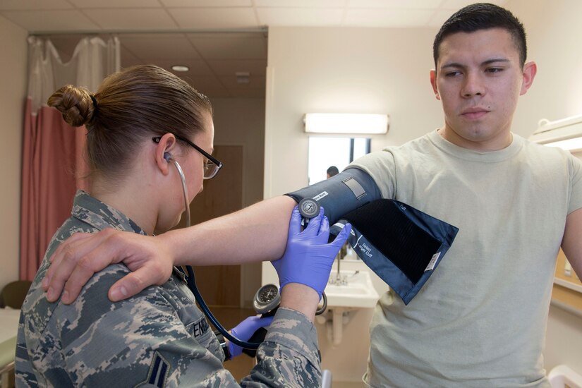 U.S. Air Force Airman 1st Class Alyssa England and Senior Airman Michael Ayala, 633rd Medical Operations Squadron cardiopulmonary laboratory technicians,  demonstrate how to measure blood pressure at Joint Base Langley-Eustis, Virginia, Feb. 26, 2018. Checking blood pressure is one way of measuring heart health. (U.S. Air Force photo by Airman 1st Class Monica Roybal)