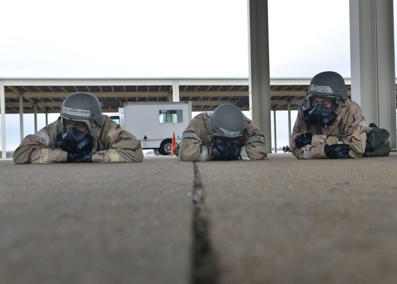 U.S. Air Force Airmen wait for an all-clear alert during a Chemical Attack Survival Familiarization exercise at Joint Base Langley- Eustis, Virginia, Feb. 26, 2018.