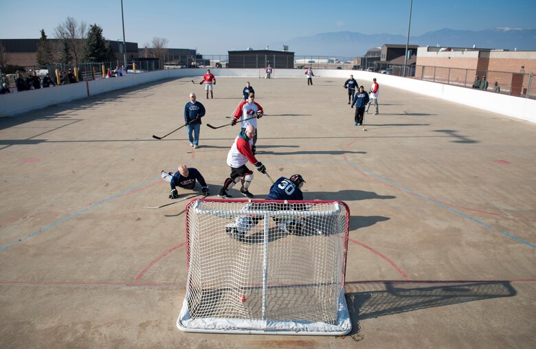 PETERSON AIR FORCE BASE, Colo. – Canadians and Americans compete in the annual USA vs. Canada Ball Hockey Game at Peterson Air Force Base, Colo., Feb. 23, 2018. Service members and civilians from North American Aerospace Defense Command, Air Force Space Command, Cheyenne Mountain Air Force Station and Peterson AFB, Colo., participated in the game. The Americans defeated the Canadians 3-2. (U.S. Air Force photo by Senior Airman Dennis Hoffman)