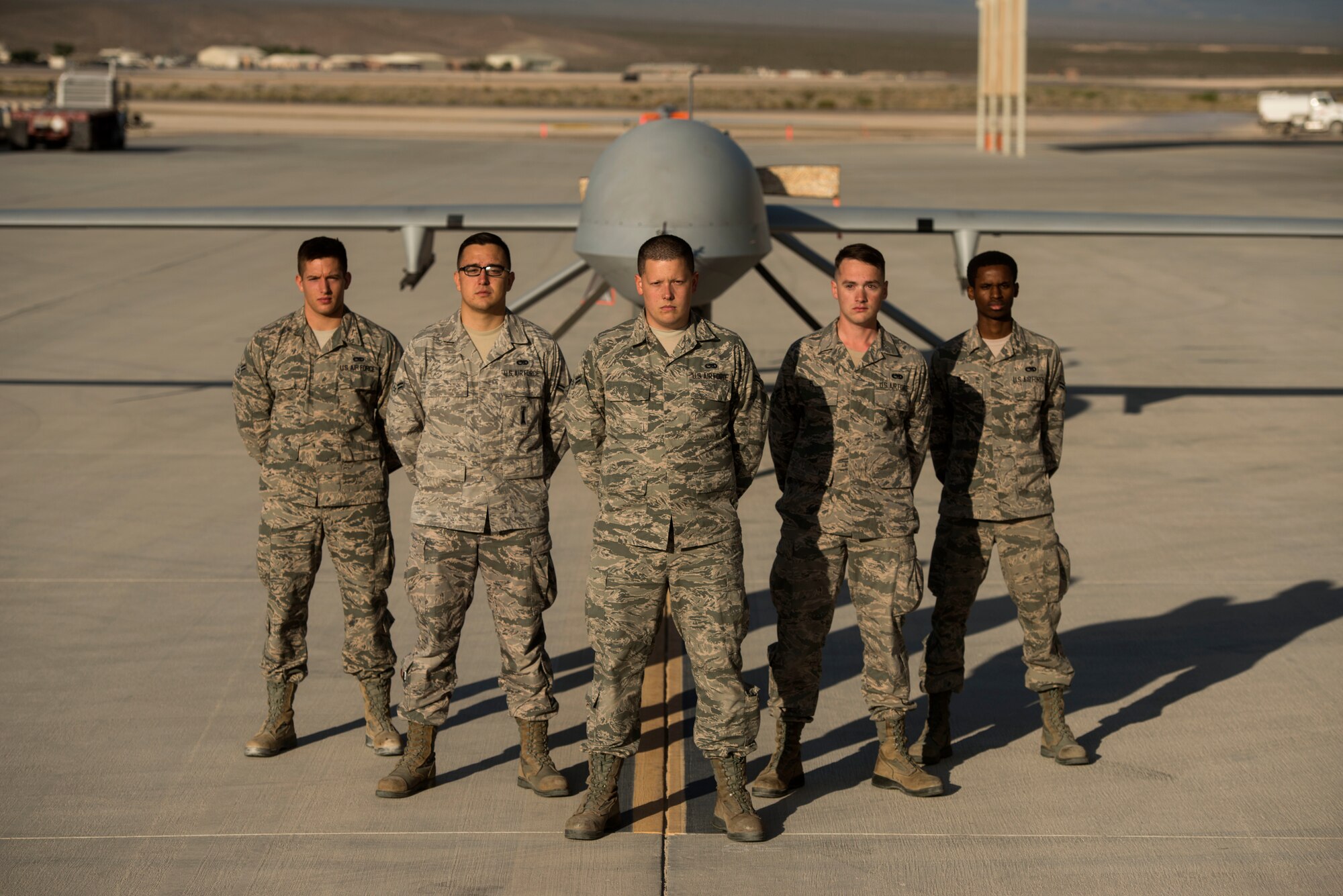 432nd Aircraft Maintenance Squadron maintainers stand in front of an MQ-1 Predator May, 5, 2015, at Creech 
Air Force Base, Nev. The Predator is an armed multi-role Remotely Piloted Aircraft supporting combatant commander's downrange with persistent attack and reconnaissance capabilities. (U.S. Air Force photo by Tech. Sgt. Vernon Young Jr.)