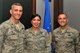 U.S. Air Force Tech. Sgt. Jillian Clamor, 20th Contracting Squadron medical commodities section chief, center, is recognized by Col. Daniel Lasica, 20th Fighter Wing (FW) commander, left, and Chief Master Sgt. Daniel Hoglund, 20th FW command chief, at Shaw Air Force Base, S.C., Feb. 28, 2018.