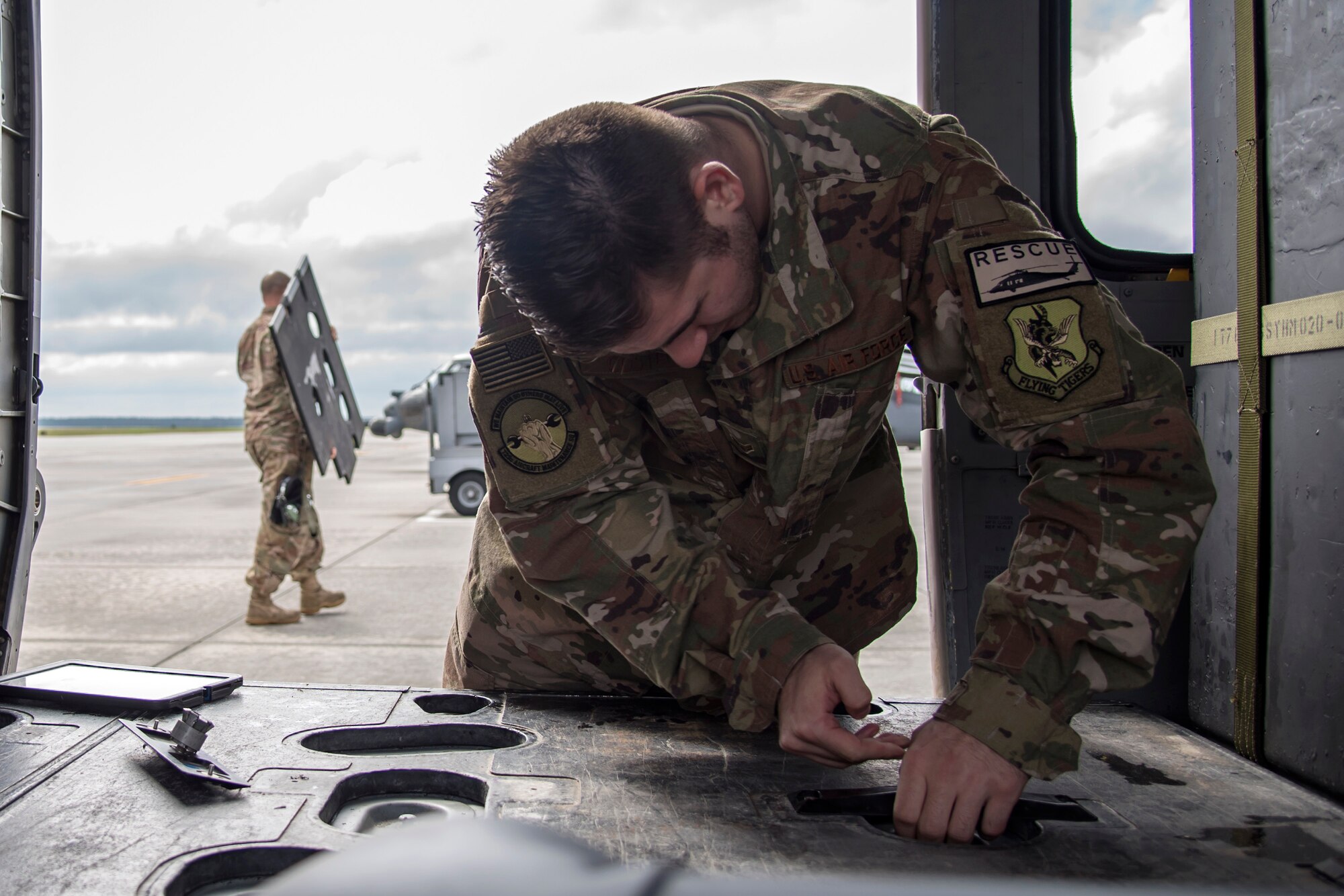 Airman 1st Class Joshua Costello, 723d Aircraft Maintenance Squadron (AMXS) crew chief, removes a cover panel from the interior of an HH-60G Pavehawk, Feb. 27, 2018, at Moody Air Force Base, Ga. They were evaluated on their ability to unfold the tail and main rotors of a Pavehawk to practice making the helicopter operational in a limited amount of time.  (U.S. Air Force photo by Airman Eugene Oliver)