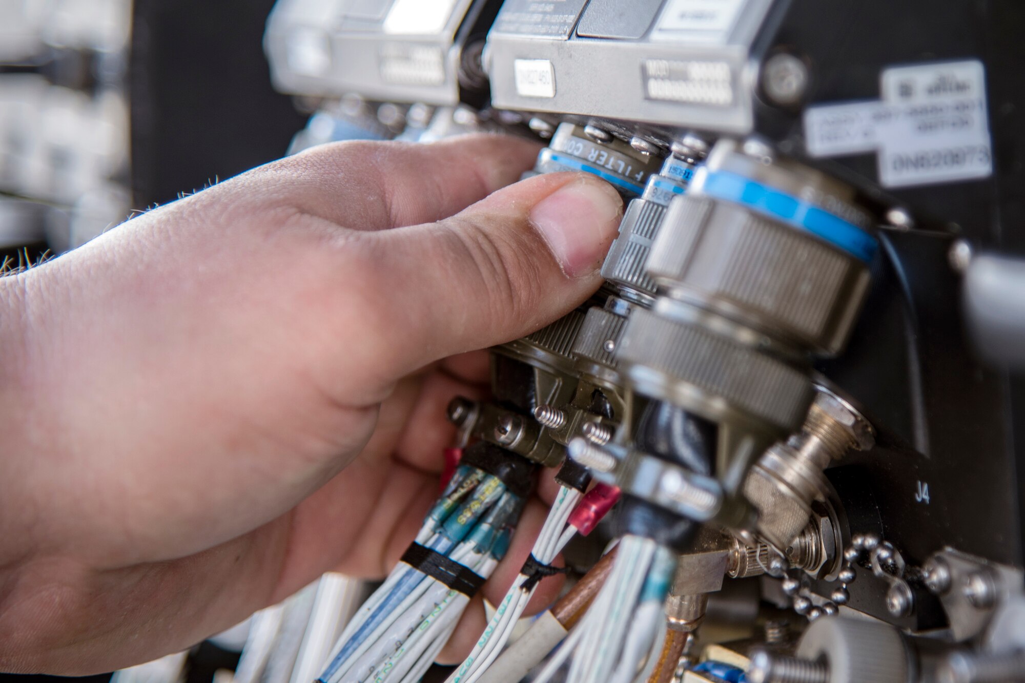 An airman from the 723d Aircraft Maintenance Squadron (AMXS) inserts canon plugs into the electronic system of an HH-60G Pavehawk, Feb. 27, 2018 at Moody Air Force Base, Ga. They were evaluated on their ability to unfold the tail and main rotors of a Pavehawk to practice making the helicopter operational in a limited amount of time. (U.S. Air Force photo by Airman Eugene Oliver)