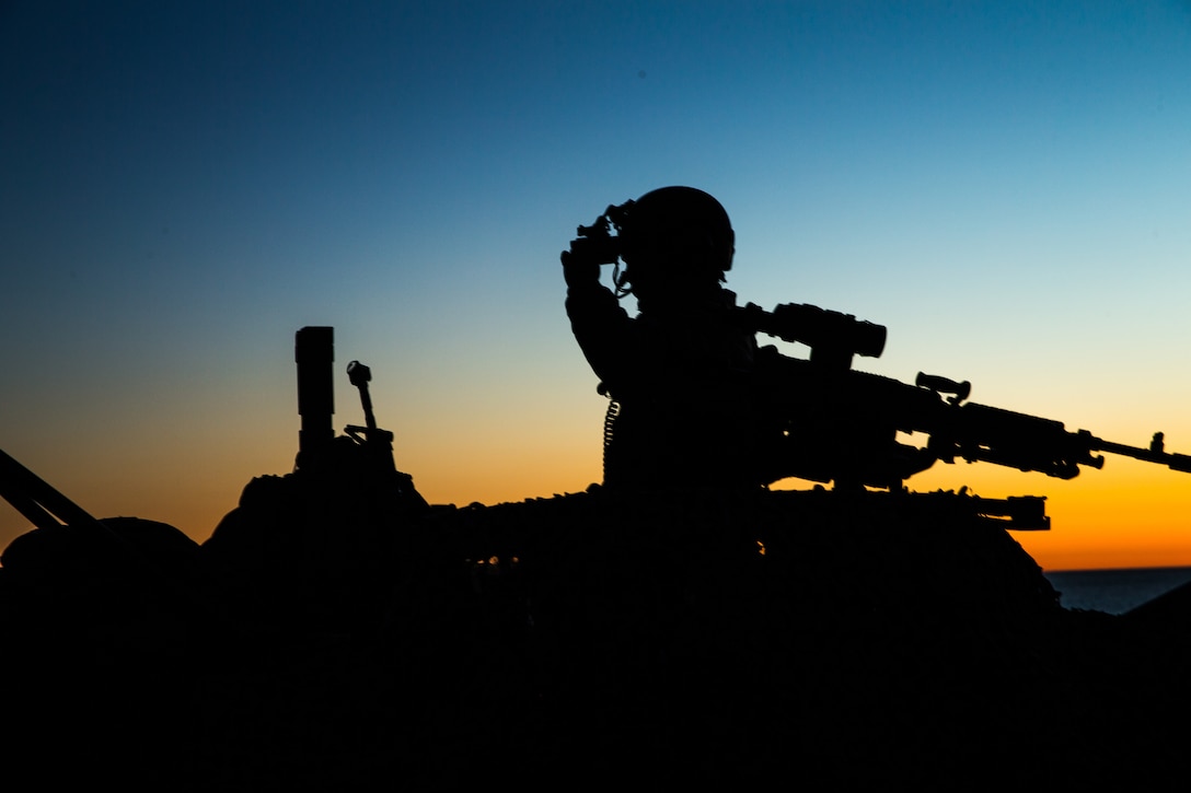 A Marine with 1st Light Armored Reconnaissance Battalion, 1st Marine Division adjusts his night vision as the sun set on Marine Corps Base Camp Pendleton, Calif., Feb. 20, 2018. 1st Light Armored Reconnaissance Battalion conducted a night raid training exercise at Military Operations on Urban Terrain (MOUT) Area 25 in order to maintain mission readiness. (Marine Corps photo by PFC. Stephen Beard)
