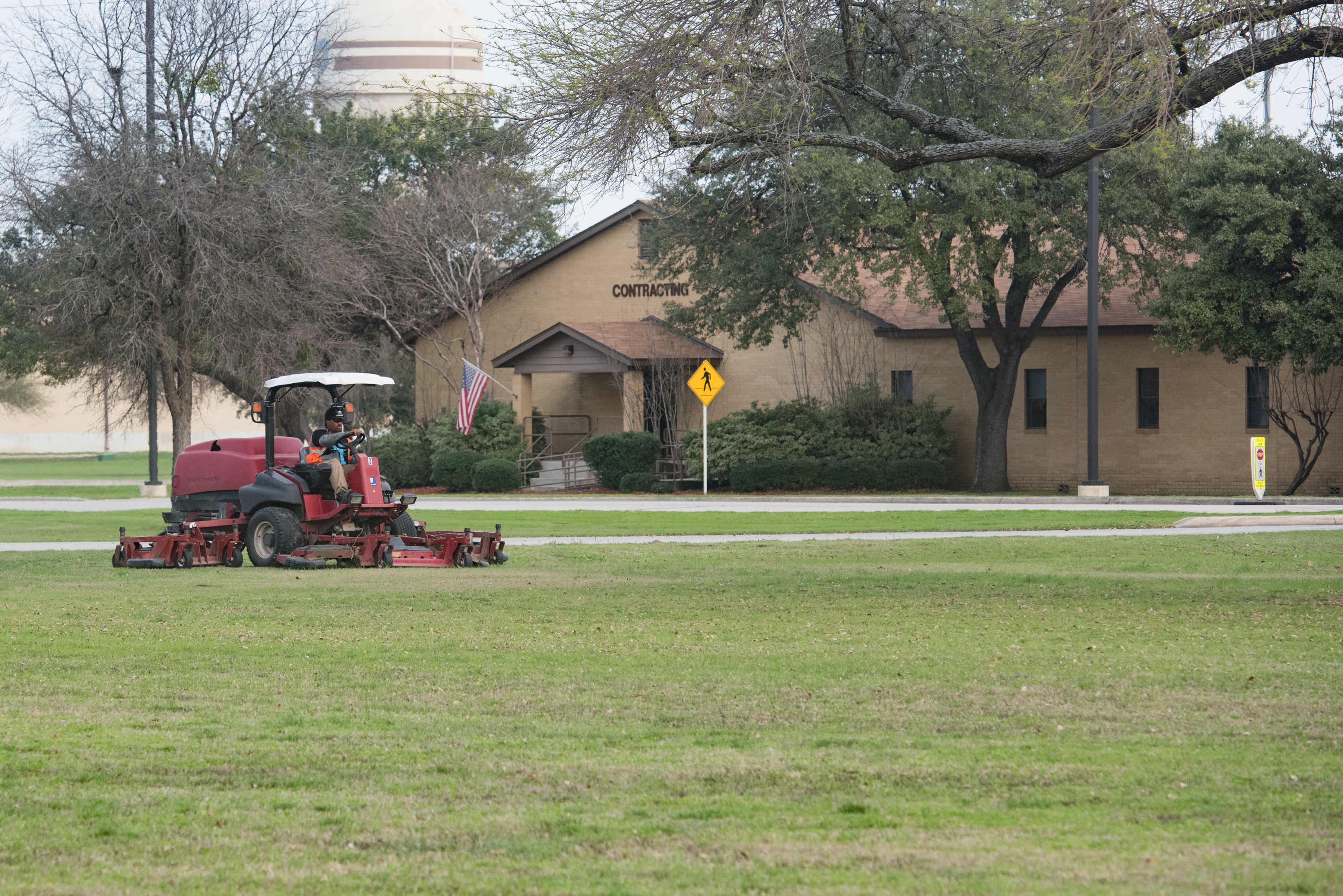 JBSALackland Grounds Maintenance worker cutting grass in field