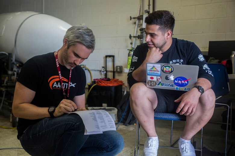 Luis Rios and Leon Harding, members of the hyperspectral thermal emission spectrometer instrumentation team, review a procedure checklist prior to an ER-2 aircraft flight, Marine Corps Air Station Kaneohe Bay, Feb. 2, 2018. The flights, a part of NASA’s HyspIRI preparatory campaign, aim to gather environmental data from the Hawaiian Islands, such as coral reef health and volcanic activity, to ultimately pave the way for the deployment of a satellite sharing the same mission. (U.S. Marine Corps photo by Lance Cpl. Luke Kuennen)
