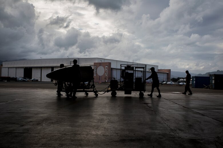 Members of NASA’s HyspIRI preparatory campaign prepare to mount a data collection instrument on their ER-2 aircraft, Marine Corps Air Station Kaneohe Bay, Feb. 2, 2018. The campaign’s goal is to gather environmental data from the Hawaiian Islands, such as coral reef health and volcanic activity, to ultimately pave the way for the deployment of a satellite sharing the same mission. (U.S. Marine Corps photo by Lance Cpl. Luke Kuennen)