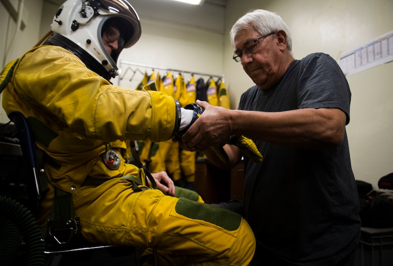 Tim Williams, a research test pilot with NASA’s HyspIRI preparatory campaign, is helped into his pressure suit prior to an ER-2 aircraft flight, Marine Corps Air Station Kaneohe Bay, Feb. 2, 2018. The campaign’s goal is to gather environmental data from the Hawaiian Islands, such as coral reef health and volcanic activity, to ultimately pave the way for the deployment of a satellite sharing the same mission. (U.S. Marine Corps photo by Lance Cpl. Luke Kuennen)