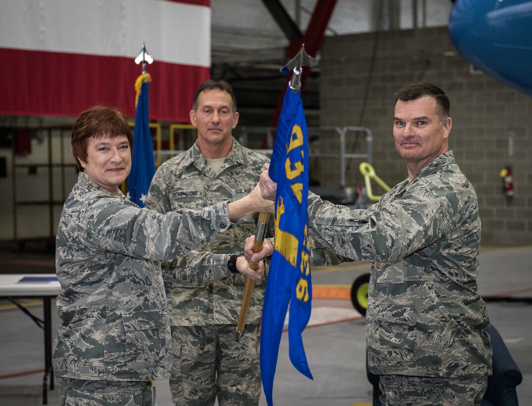 new MXS commander, Maj. Dwayne Cantrell takes receives the MXS guidon during change of command ceremony