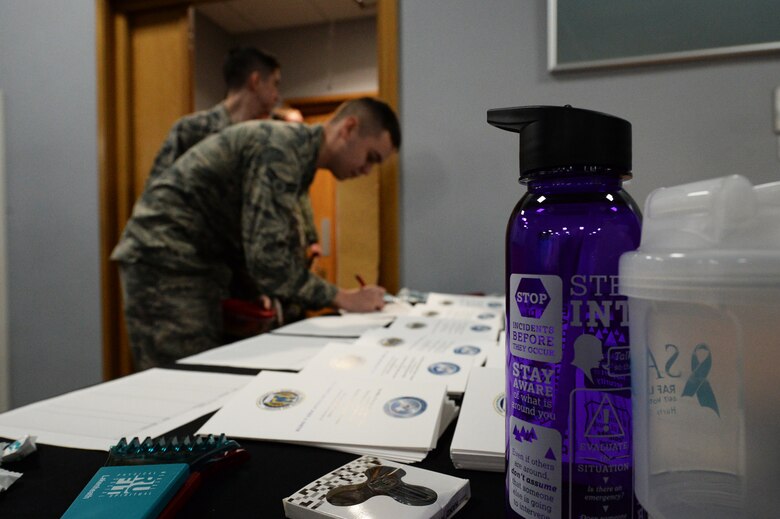 (courtesy photo) An Airman signs the attendance roster for the mock trial hosted at the Strike Eagle Complex at Royal Air Force Lakenheath, England, Feb. 22, 2018. Airmen, dependents and civilians were invited to get an inside view of what happens during a military court martial. (U.S. Air Force photo/Airman 1st Class Shanice Williams-Jones)