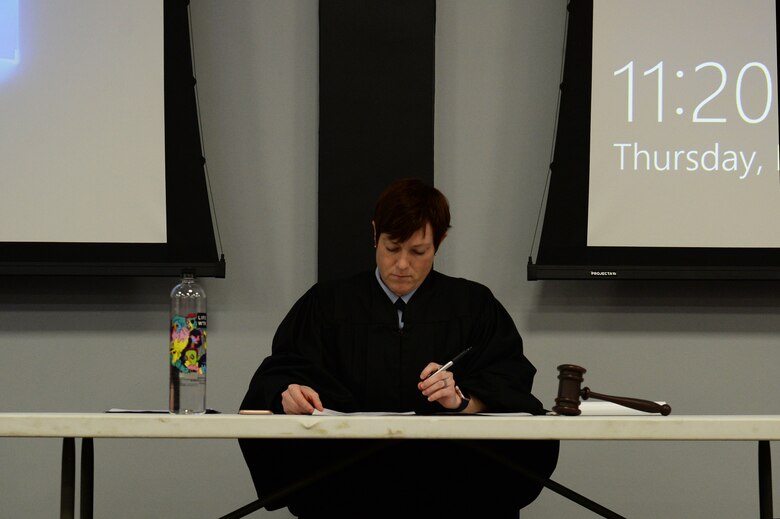 (courtesy photo) Maj. September R. Foy, the deputy staff judge advocate assigned to the 501st Combat Support Wing, plays the role of military judge during a sexual assault mock trial at Royal Air Force Lakenheath, England, Feb. 22, 2018. As the presiding judge, after hearing oral arguments, she ruled on a motion raised by the defense and explained to the audience how she came to that decision. (U.S. Air Force photo/Airman 1st Class Shanice Williams-Jones)