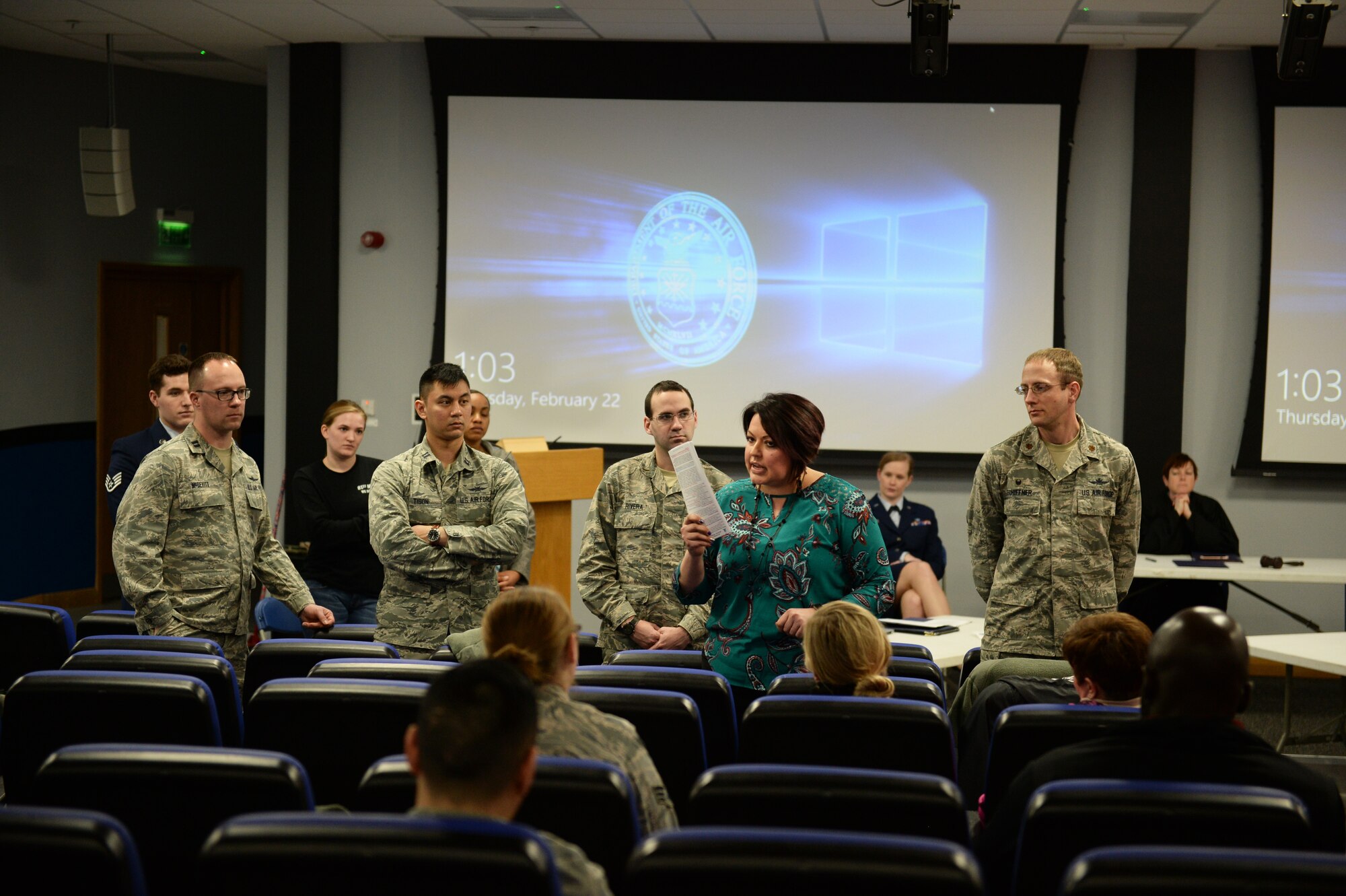 (courtesy photo) Carolina A. Yepez, the sexual assault prevention and response coordinator assigned to the 48th Fighter Wing, briefs the audience at a mock trial at the Strike Eagle Complex on Royal Air Force Lakenheath, England, Feb. 22, 2018. Yepez asked several audience members to stand as a visual aide to depict how many individuals are involved in the initial reporting of sexual assault. (U.S. Air Force photo/Airman 1st Class Shanice Williams-Jones)
