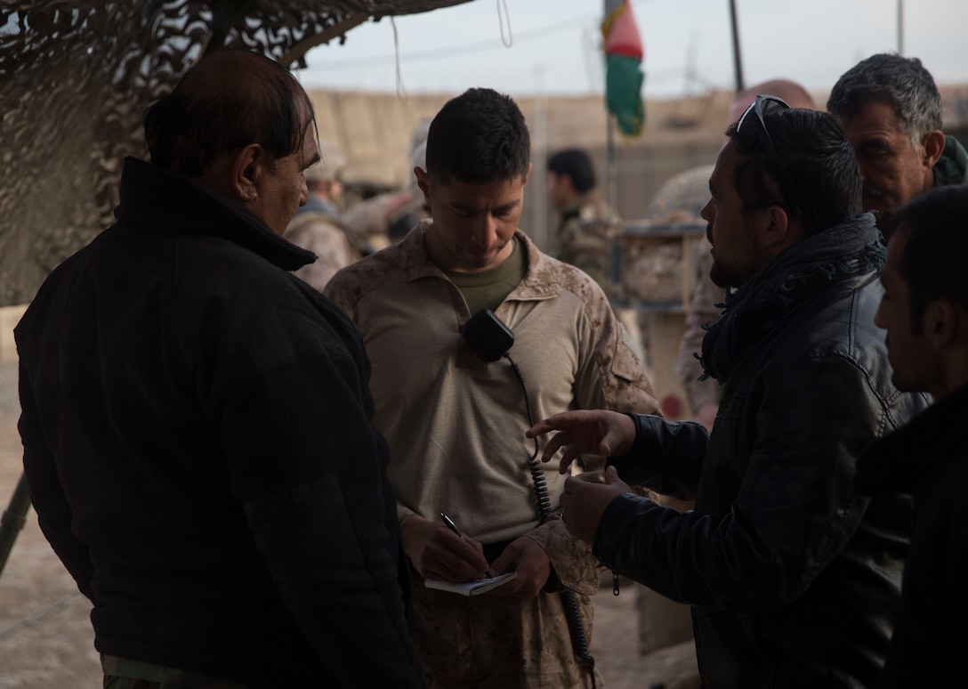 A U.S. Marine advisor with Task Force Southwest assists his counterpart, Afghan National Army Brig. Gen. Abdul Raziq Hotak, the commander of the 1st Brigade, 215th Corps in battle tracking during operation Maiwand 10 in Helmand Province, Afghanistan, Dec. 25, 2017. Task Force Southwest is advising and assisting the 1st Brigade as they clear southern Marjah as part of the Maiwand 10 mission. This is a joint operation with maneuver elements from the Afghan National Army, National Directorate of Security and Afghan National Police forces. (U.S. Marine Corps photo by Sgt. Justin T. Updegraff)