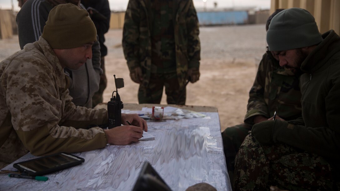 A U.S. Marine advisor with Task Force Southwest gives a grid location to the Afghan Tactical Air Coordinator’s during operation Maiwand 10 in Helmand Province, Afghanistan, Dec. 26, 2017.  These locations allowed the ATACs to coordinate with Afghan Air to support 1st Brigade on the ground, as they clear Marjah of the enemy and improvised explosive devices. (U.S. Marine Corps photo by Sgt. Justin T. Updegraff)