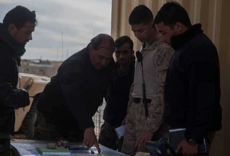 A U.S. Marine advisor with Task Force Southwest battle tracks with Afghan National Army Brig. Gen. Abdul Raziq Hotak, the commander of the 1st Brigade, during operation Maiwand 10 in Helmand Province, Afghanistan, Dec. 25, 2017. Task Force Southwest is advising and assisting the 1st Brigade as they clear southern Marjah as part of the Maiwand 10 mission. This is a joint operation with maneuver elements from the Afghan National Army, National Directorate of Security and Afghan National Police forces. (U.S. Marine Corps photo by Sgt. Justin T. Updegraff)