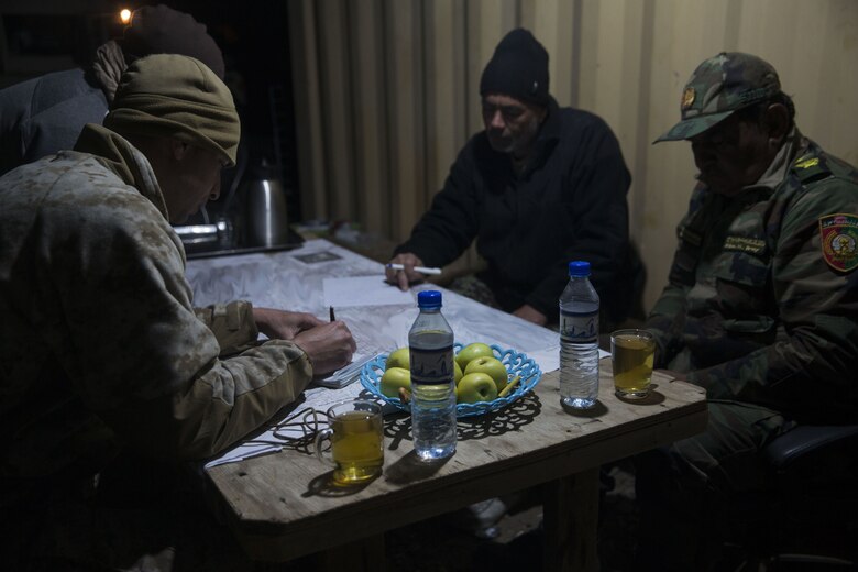 A U.S. Marine advisor with Task Force Southwest discusses the course of action for the next day with Afghan National Army Brig. Gen. Abdul Raziq Hotak, the commander of the 1st Brigade, 215th Corps during operation Maiwand 10 in Helmand Province, Afghanistan, Dec. 26, 2017. Task Force Southwest is advising and assisting the 1st Brigade as they clear southern Marjah as part of the Maiwand 10 mission. This is a joint operation with maneuver elements from the Afghan National Army, National Directorate of Security and Afghan National Police forces. (U.S. Marine Corps photo by Sgt. Justin T. Updegraff)