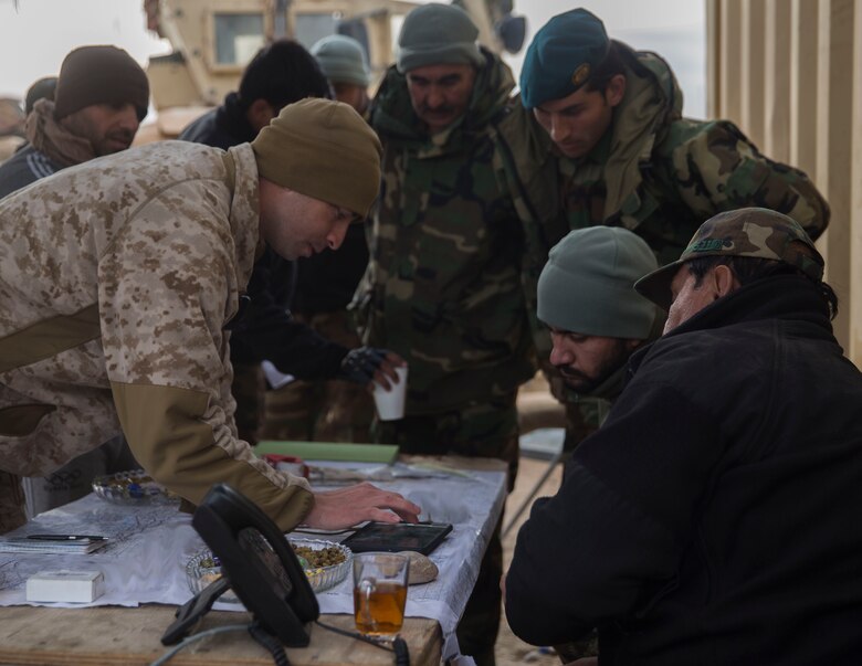 A U.S. Marine advisor with Task Force Southwest shows a possible enemy location to the Afghan Tactical Air Coordinator’s during operation Maiwand 10 in Helmand Province, Afghanistan, Dec. 26, 2017.  This location allowed the ATACs to coordinate with Afghan Air to support 1st Brigade maneuver on the ground as they clear Marjah of the enemy and improvised explosive devices. (U.S. Marine Corps photo by Sgt. Justin T. Updegraff)
