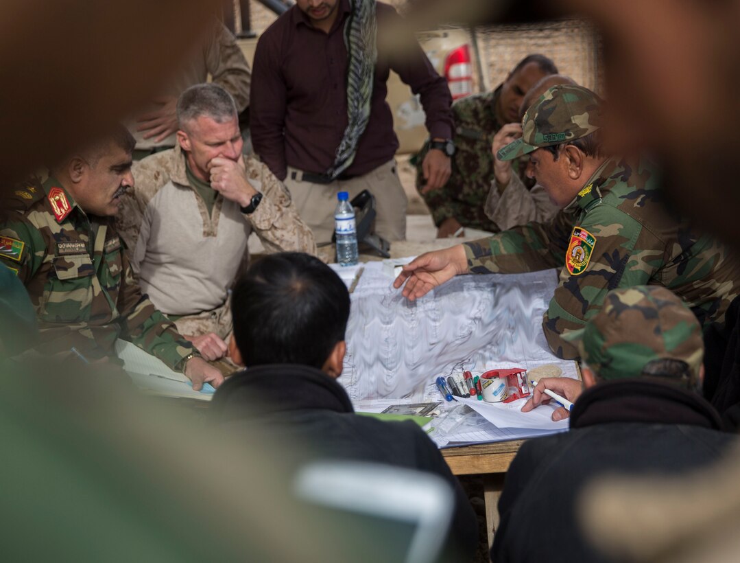 Afghan National Army Brig. Gen. Abdul Raziq Hotak, the commander of the 1st Brigade, 215th Corps discusses recent advances made by the 1st Brigade during operation Maiwand 10 in Helmand Province, Afghanistan, Dec. 26, 2017.  Task Force Southwest is advising and assisting the 1st Brigade as they clear southern Marjah as part of the Maiwand 10 mission. This is a joint operation with maneuver elements from the Afghan National Army, National Directorate of Security and Afghan National Police forces. (U.S. Marine Corps photo by Sgt. Justin T. Updegraff)