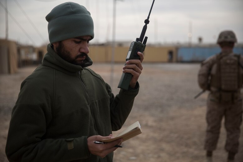 An Afghan Tactical Air Coordinator with 1st Brigade, 215th Corps communicates with an MD-530 helicopter in support of operation Maiwand 10 in Helmand Province, Afghanistan, Dec. 26, 2017. This coordination allows Afghan Air to support 1st Brigade maneuver on the ground as they clear Marjah of the enemy and improvised explosive devices. (U.S. Marine Corps photo by Sgt. Justin T. Updegraff)