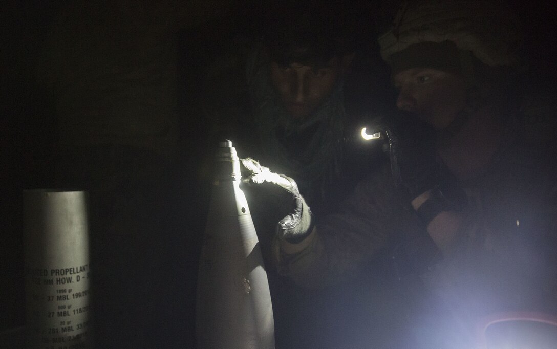 A U.S. Marine advisor with Task Force Southwest verifies the fuse timing on a 122mm round to ensure precise illumination at the intended target during Maiwand 10 in Helmand Province, Afghanistan, Dec. 27, 2017. The artillerymen with 1st Brigade, 215th Corps fired an illumination round near a bed-down site to raise the morale of the Afghan National Army Soldiers, showcasing that they can provide artillery support at any time during the operation. (U.S. Marine Corps photo by Sgt. Justin T. Updegraff)