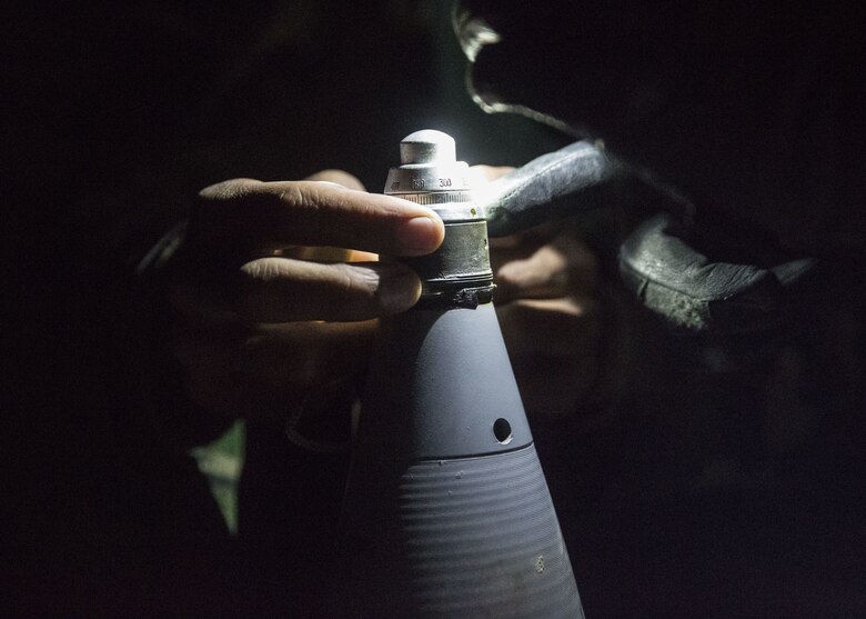 An Afghan National Army artilleryman with 1st Brigade, 215th Corps checks the fuse on a 122mm round for a D-30 during operation Maiwand 10 in Helmand Province, Afghanistan, Dec. 27, 2017. The artillerymen with 1st Brigade fired an illumination round near a bed-down site to raise the morale of the Afghan National Army Soldiers, showcasing that they can provide artillery support at any time during the operation. (U.S. Marine Corps photo by Sgt. Justin T. Updegraff)