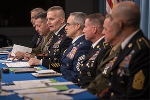 Senior Enlisted Leaders sit at a table together.