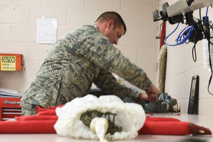 Tech. Sgt. Christopher Brawner repacks a parachute.