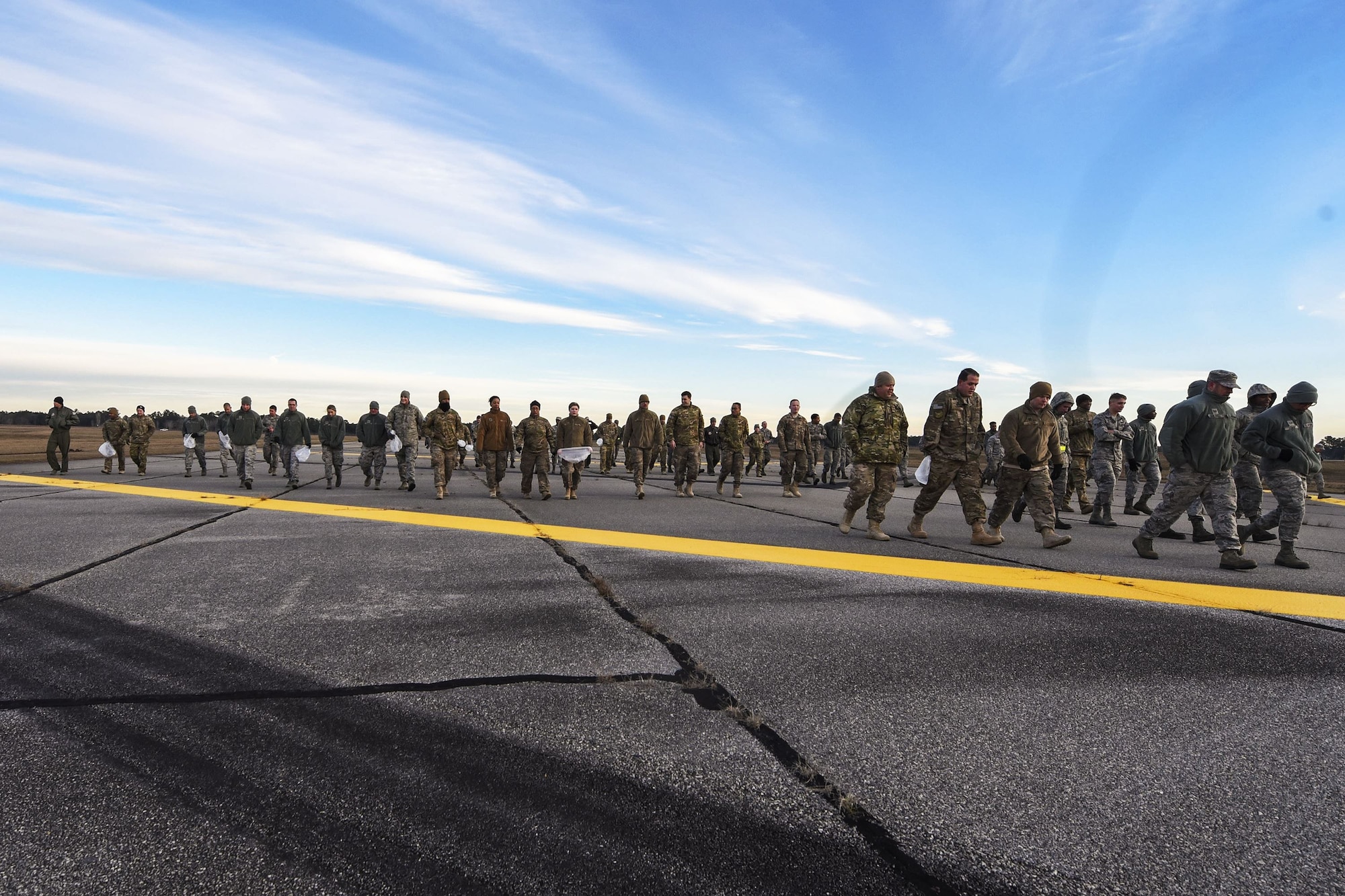 Team Moody Airmen, walk on the flight line during a foreign object debris (FOD) walk, Jan. 2, 2018, at Moody Air Force Base, Ga.  The FOD walk was performed following the winter holidays to remove any debris that could potentially cause damage to aircraft or vehicles. (U.S. Air Force photo by Airman Eugene Oliver)