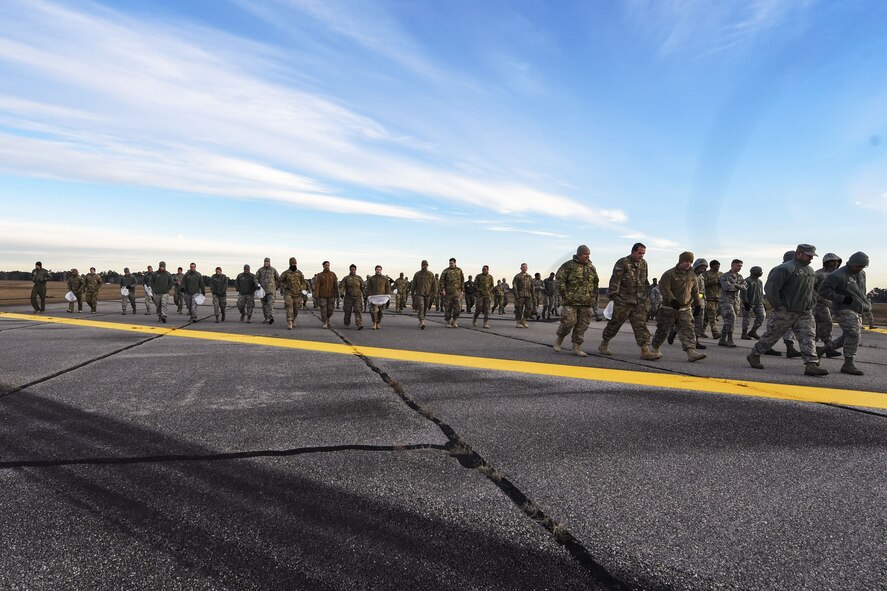 Team Moody Airmen, walk on the flight line during a foreign object debris (FOD) walk, Jan. 2, 2018, at Moody Air Force Base, Ga.  The FOD walk was performed following the winter holidays to remove any debris that could potentially cause damage to aircraft or vehicles. (U.S. Air Force photo by Airman Eugene Oliver)