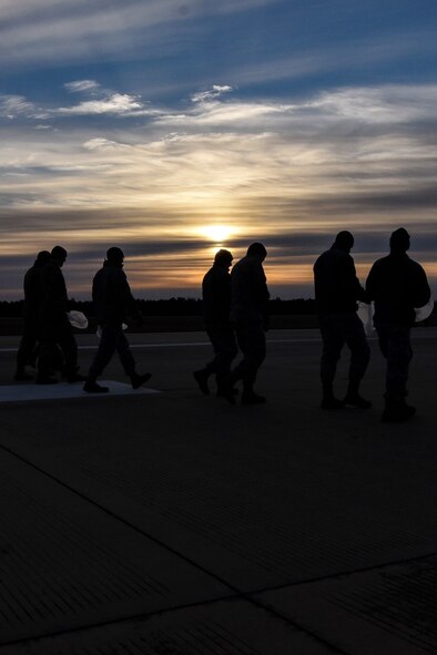 Team Moody Airmen inspect the flight line during a foreign object debris (FOD) walk, Jan. 2, 2018, at Moody Air Force Base, Ga.  The FOD walk was performed following the winter holidays to remove any debris that could potentially cause damage to aircraft or vehicles. (U.S. Air Force photo by Airman Eugene Oliver)