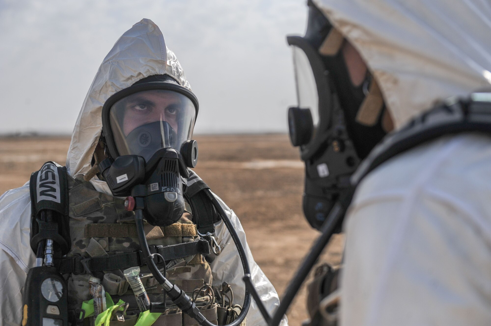 Tech Sgt. Charles Piccolomini, 380th Expeditionary Civil Engineer Squadron, explosive ordnance disposal, logistics section chief, evaluates his wingman on the implementation of EOD procedures during the Major Accident Reponses Exercise at Al Dhafra Air Base, United Arab Emirates Dec 15, 2017. The MARE is designed to test and evaluate the procedures of first responders. (U.S. Air National Guard Photo by Staff Sgt. Colton Elliott)