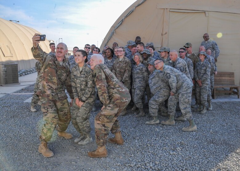 Lt. Gen. Scott Rice, director of the Air National Guard, and Chief Master Sgt. Ronald Anderson, command chief master sergeant of the Air National Guard takes a selfie with Senior Airman Morgan McCormick, 727th Expeditionary Air Control Squadron, electronic protection technician at Al Dhafra Air Base, United Arab Emirates Dec. 26, 2017. Rice texted the photo to McComick’s family and thanked them for their sacrifices and wished them a Merry Christmas. 
(U.S. Air National Guard Photo by Staff Sgt. Colton Elliott)
