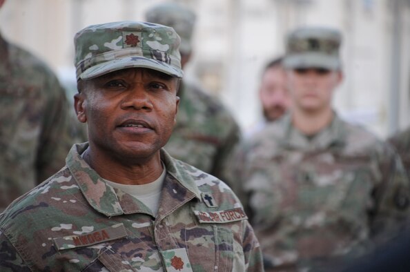 Maj. Laserian Nwoga, 380th Air Expeditionary Wing, chaplain, delivers an opening prayer during a remembrance ceremony at Al Dhafra Air Base, United Arab Emirates Dec. 21, 2017. The ceremony highlighted the heroic actions of Security Forces Airmen and Office of Special Investigations special agents who lost their lives during combat operations. (U.S. Air National Guard Photo by Staff Sgt. Colton Elliott)