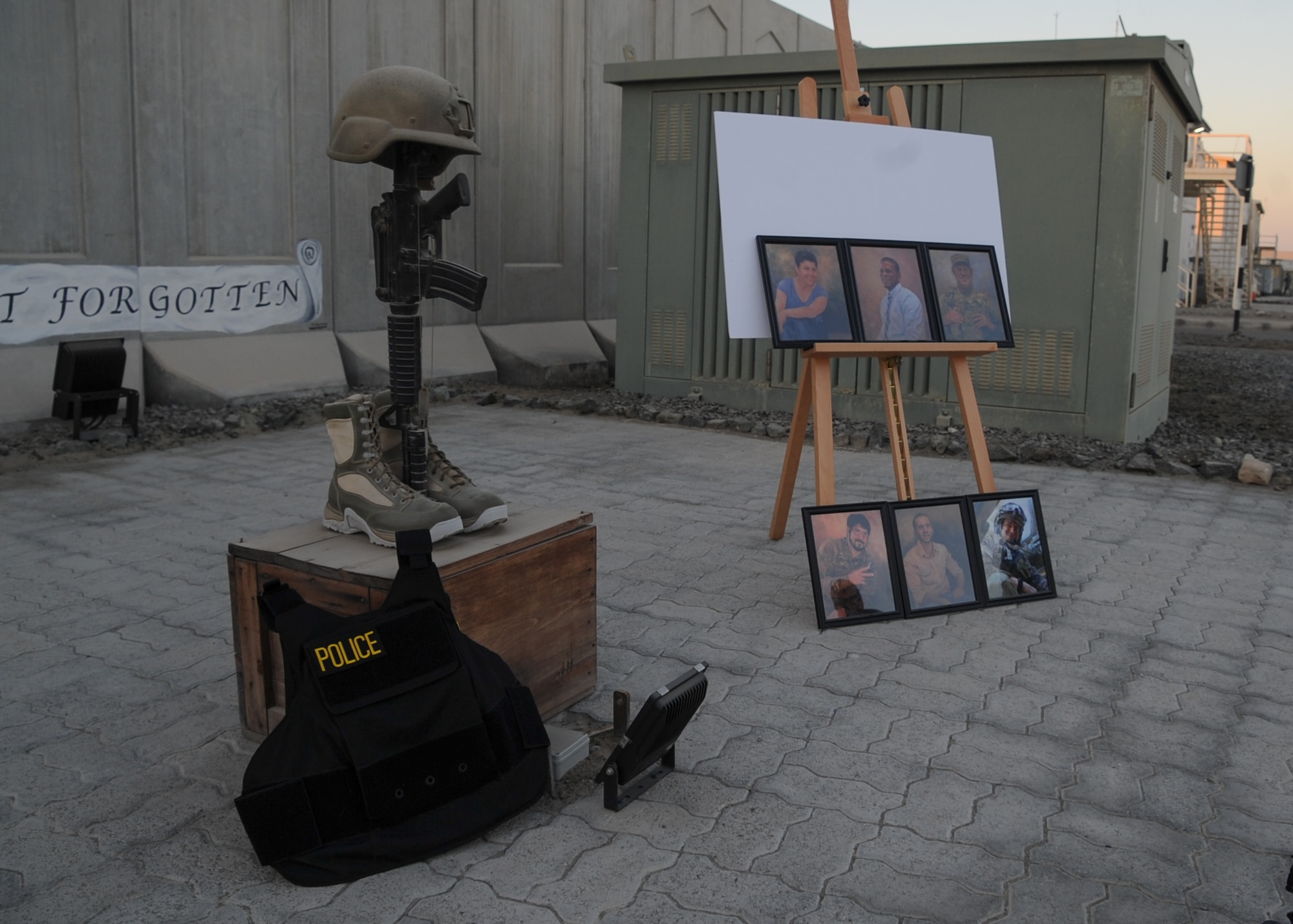 The 380th Expeditionary Wing, Security Forces Squadron, displays photos of 6 members who lost their lives in support of Operation Iraqi Freedom, Enduring Freedom, Freedom’s Sentinel and Inherent Resolve during a remembrance ceremony at Al Dhafra Air Base, United Arab Emirates Dec. 21, 2017. The ceremony highlighted the heroic actions of Security Forces Airmen and Office of Special Investigations special agents who lost their lives during combat operations. (U.S. Air National Guard Photo by Staff Sgt. Colton Elliott)