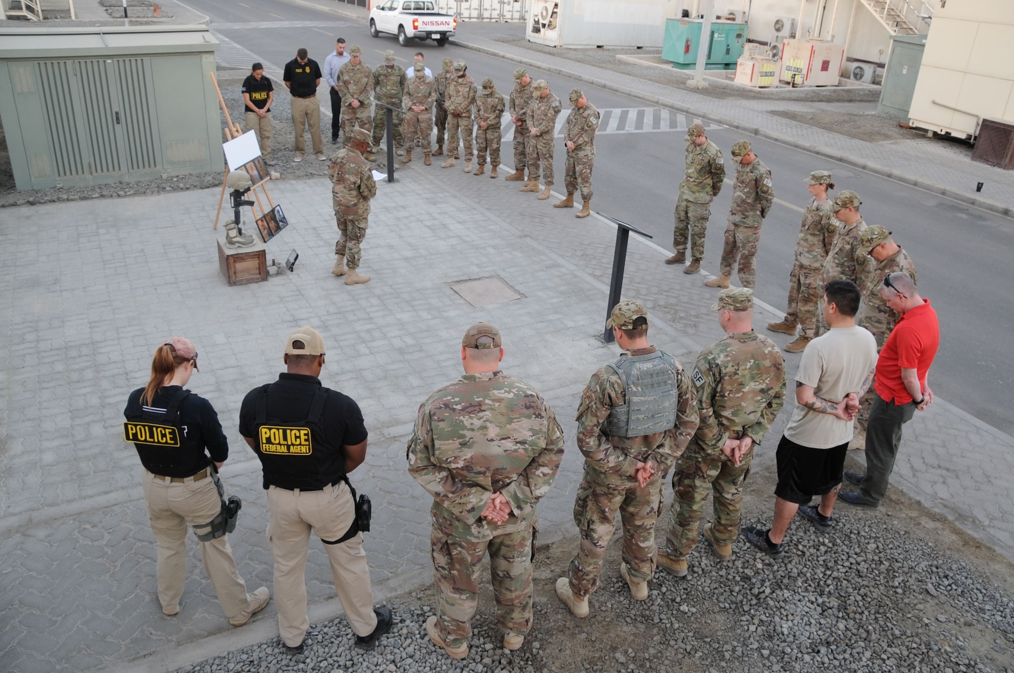 Members from the 380th Air Expeditionary Wing, gather for a remembrance ceremony at Al Dhafra Air Base, United Arab Emirates Dec. 21, 2017. The ceremony highlighted the heroic actions of Security Forces Airmen and Office of Special Investigations special agents who lost their lives during combat operations. (U.S. Air National Guard Photo by Staff Sgt. Colton Elliott)