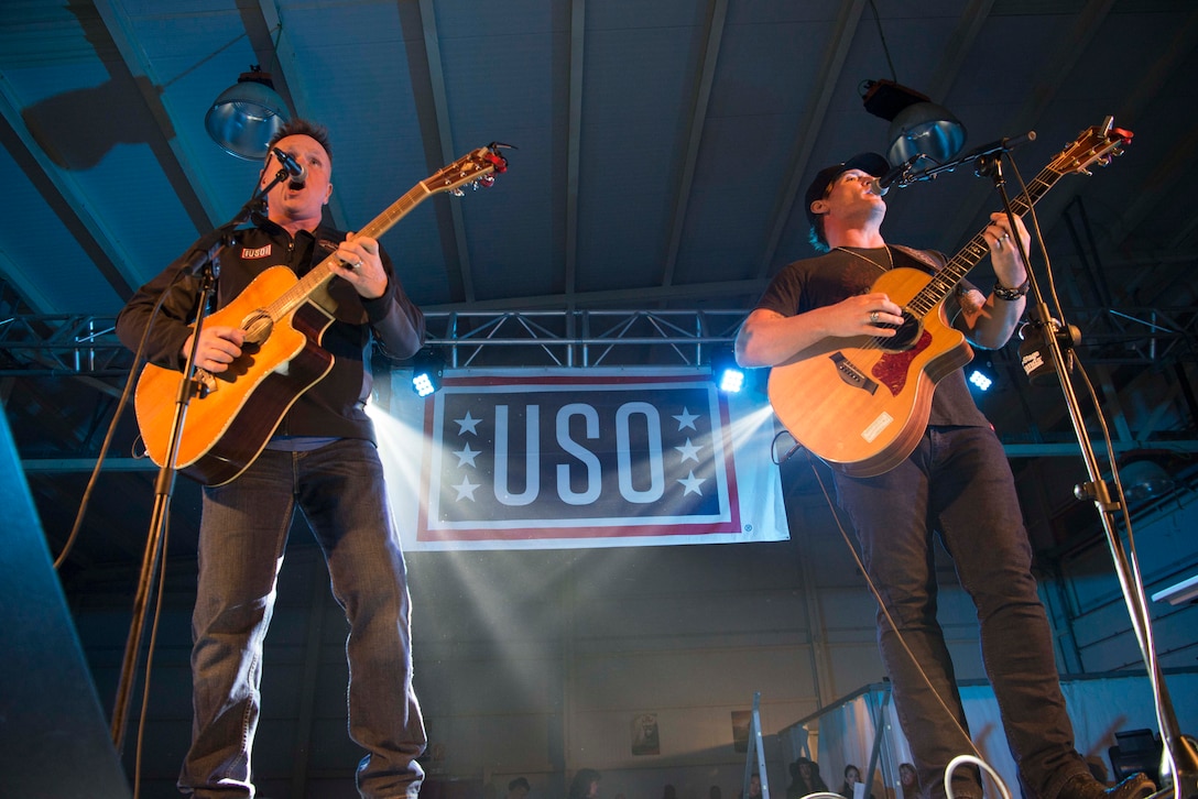 Jerrod Niemann, right, county music star, performs during the 2017 United Services Organization Holiday Tour on Morón Air Base, Spain, Dec. 21, 2017. The USO, which has been operating for 76 years, brings various entertainments to service members overseas in order to give them a taste of home. (U.S. Air Force photo by Senior Airman Elizabeth Baker)