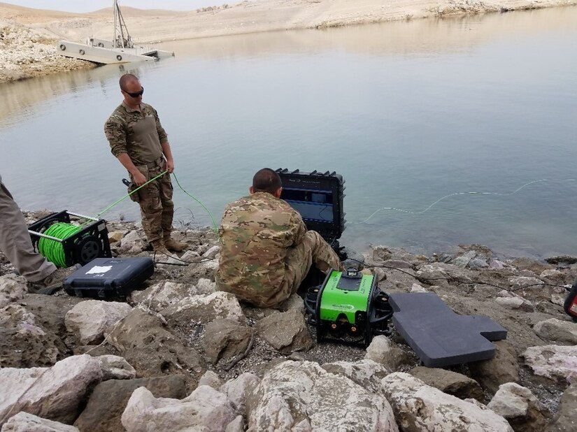 Soldiers near a body of water.