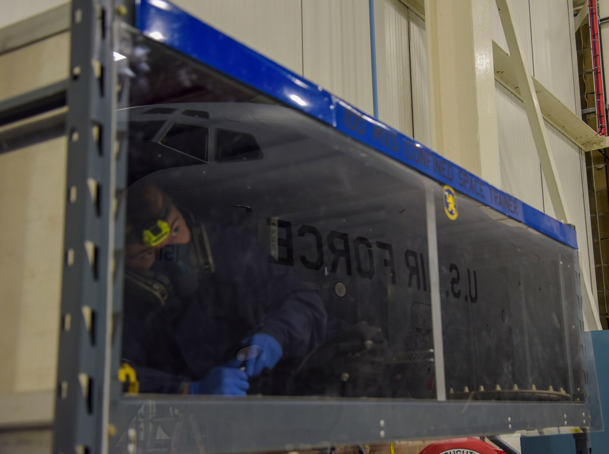 U.S. Air Force Airman Shawn Bragg, 100th Maintenance Squadron aircraft fuel systems apprentice, secures bolts inside the confined space trainer Dec. 15, 2017 on RAF Mildenhall, England. The confined space trainer better prepares Airmen when entering fuel tanks on an aircraft. (U.S. Air Force photo by Senior Airman Justine Rho)