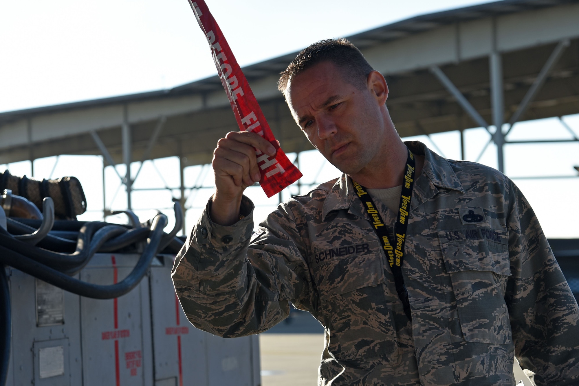 U.S. Air Force Master Sgt. Christopher Schneider, F-16 Viper Demonstration Team superintendent, inspects a “Remove Before Flight” warning ribbon attached to an F-16CM Fighting Falcon during a Proud Falcon Competition at Shaw Air Force Base, S.C., Dec. 21, 2017.