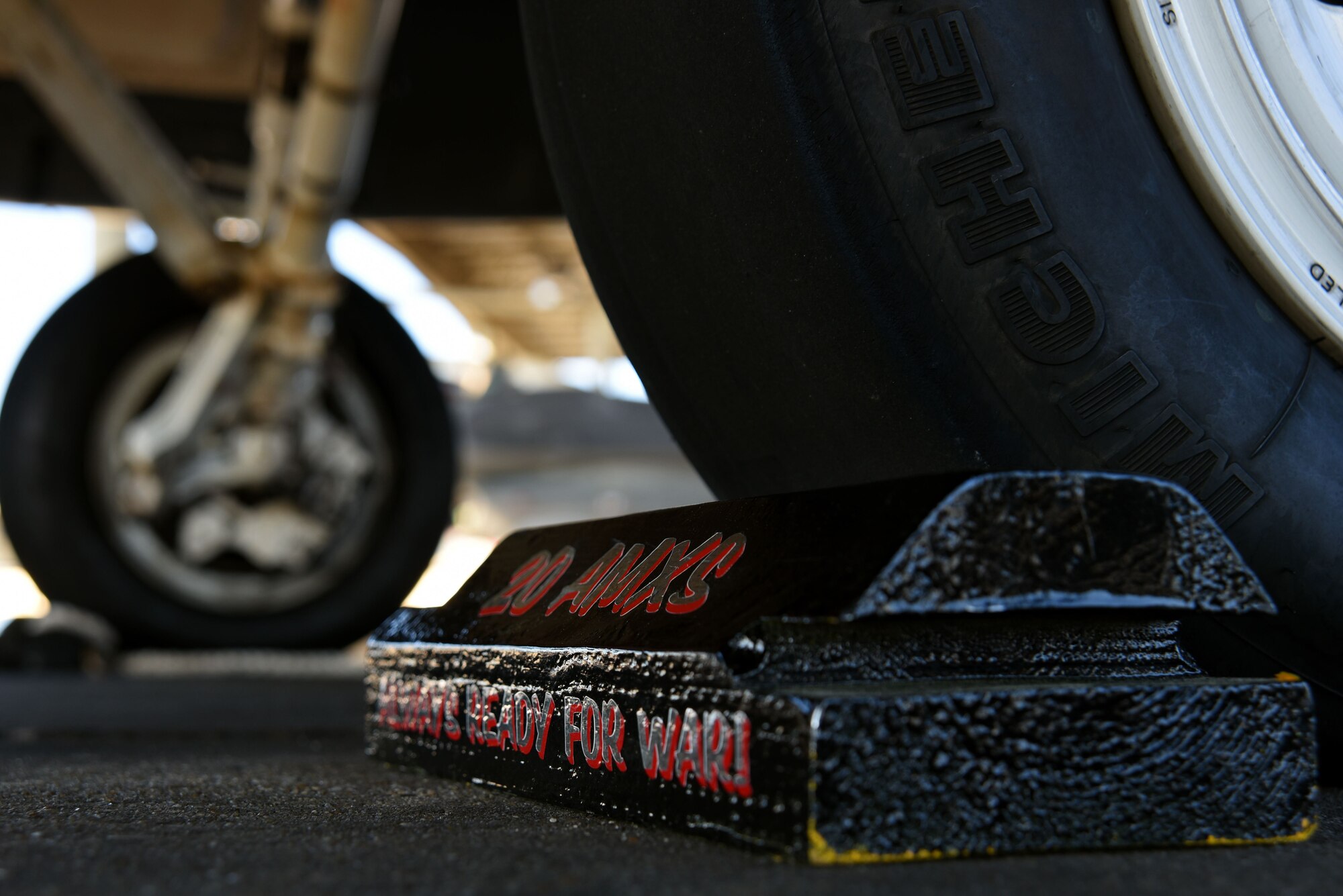 A chock rests in front of an F-16CM Fighting Falcon tire during a Proud Falcon Competition on the flightline at Shaw Air Force Base, S.C., Dec. 21, 2017.