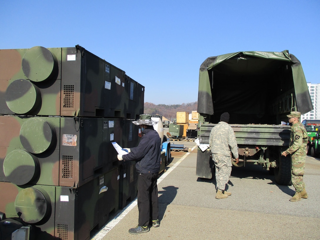 Gimcheon staff member helps soldiers locate the environmental control units that will heat up their winter training.