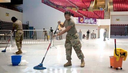 Soldiers with the 14th Combat Support Hospital, 44th Medical Brigade from Fort Benning, Georgia, clean floors to acheive a sterile environment for their hospital Oct. 8, 2017 at Humacao Arena in Humacao, Puerto Rico. The 14th CSH is in the process of establishing a field hosipital to support life saving efforts in the southeast region of the island.