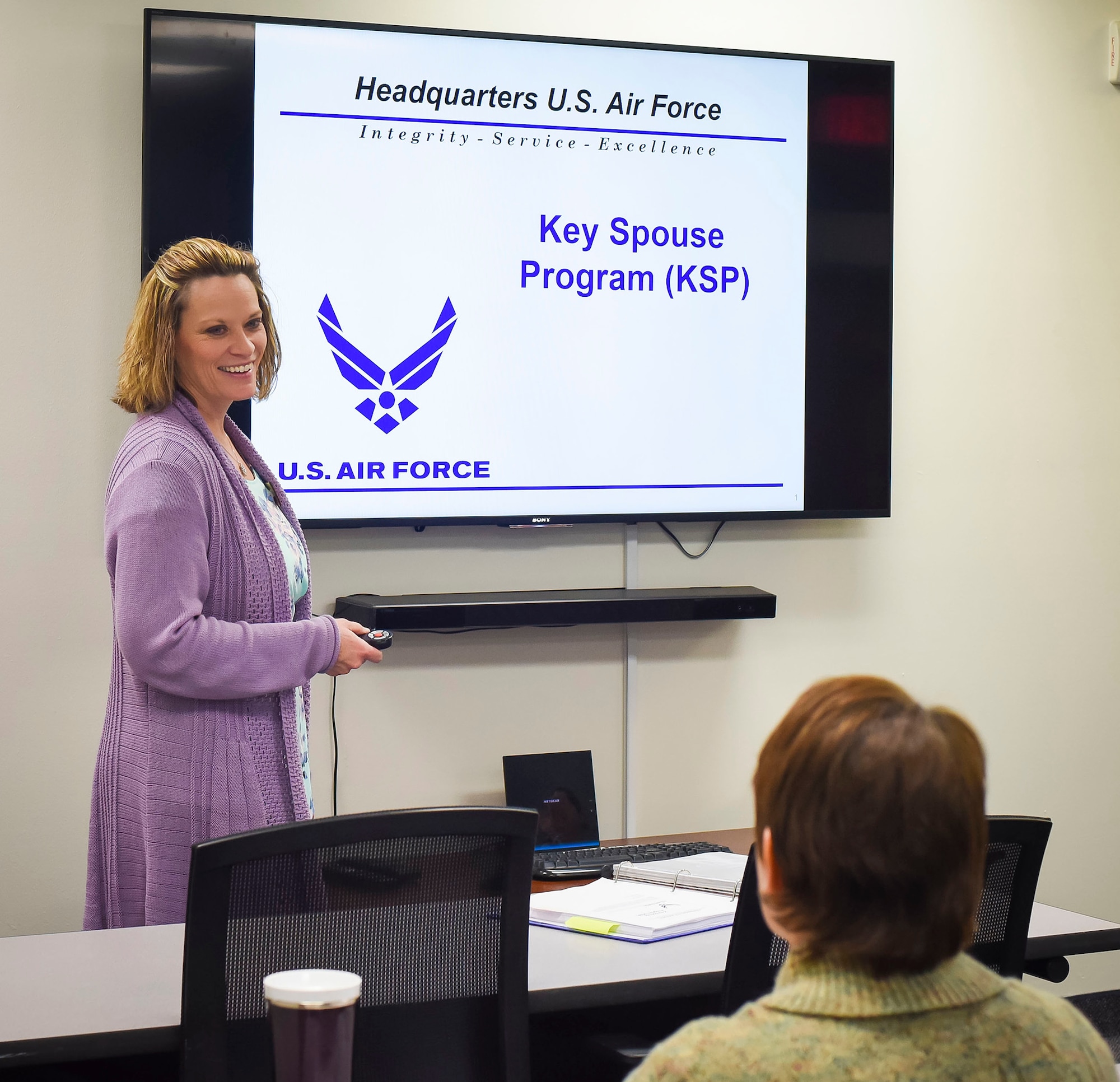 Dawn Beal is the 341st Missile Wing key spouse group program coordinator. She poses for a photo in front of an orientation slide Dec. 28, 2017, at the Airman and Family Readiness Center, Malmstrom Air Force Base, Mont. where she has been a long-time community readiness consultant. (U.S. Air Force photo by Kiersten McCutchan)